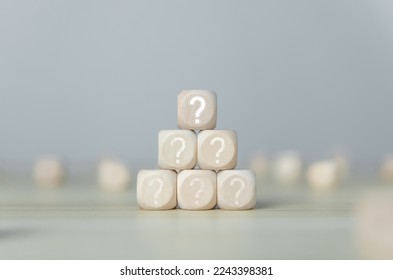 The wooden cube block shows a question mark icon. The concept of choice. Confusion. Business solution. copy space - Shutterstock ID 2243398381