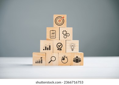 Wooden cube block step on a table with Action Plan, Goal, and Target icons. Success and business target concept. Project management and company strategy for professional growth. - Shutterstock ID 2366716753