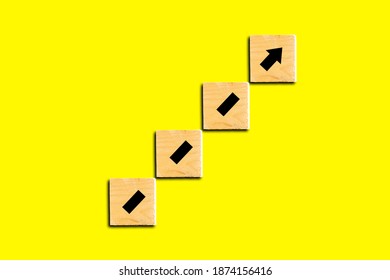 Wooden cube or blocks stacking as step stair with arrow up. Ladder of success  growth concept