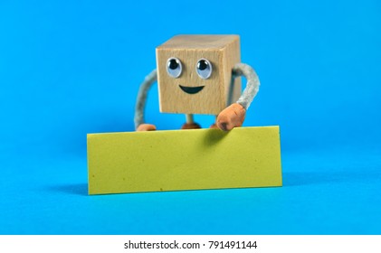 Wooden cube as a character holding a blank sign. Place for your text. - Powered by Shutterstock