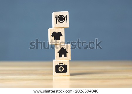 Wooden cube with food Clothing, housing, medicine, four basic human needs concept.