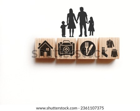 wooden cube with icons of food, Clothing, housing, medical bag, four basic human needs concepts. The Four Basic Material Needs of the Human Being. [[stock_photo]] © 