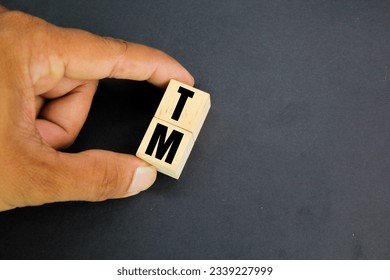 wooden cube with the letter TM. trademark concept. 