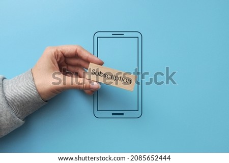 Wooden cube on the phone with the inscription: 
