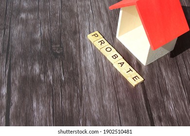 Wooden Cube With Text PROBATE And Miniature House On Wooden Background.