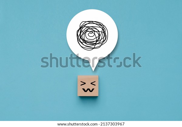 Wooden cube with unhappy face with\
a tangle of thoughts in its head, wood block with a emotion stress\
face and confused thoughts , depressed and worry for\
distress