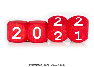wooden cube with year 2021 and 2022 built from red dices, isolated on white background