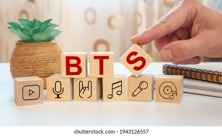 Wooden cubes with the abbreviation BTS and music icons