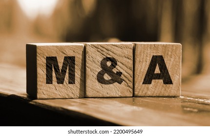 Wooden cubes with the abbreviation M and A on them. Business merges and aquisitions concept. - Shutterstock ID 2200495649