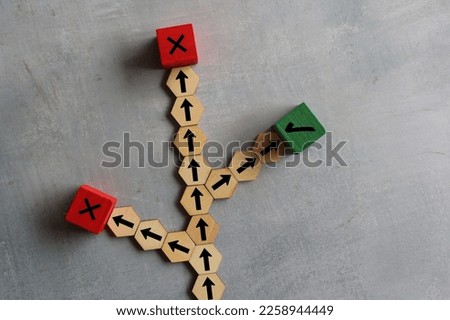 Wooden cubes with arrows, right and wrong icon. Choosing right path, road to success, alternative option concept
