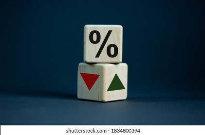 Wooden cubes changes the direction of an arrow symbolizing that the interest rates are going down or vice versa . Business concept. Copy space, beautiful grey background. - Shutterstock ID 1834800394