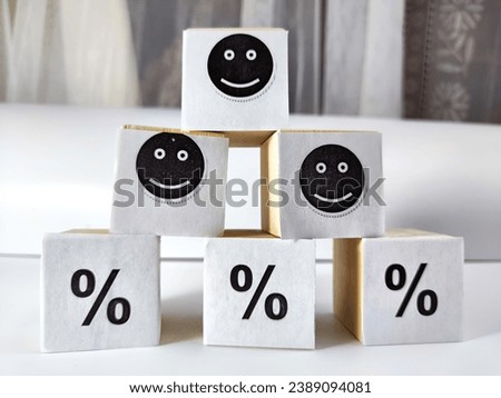 Wooden cubes in a column and row with white signs with a smiley sign, a percentage. The concept of positivism. Efforts and achievements lead to pleasure, joy, positivism and positive thinking