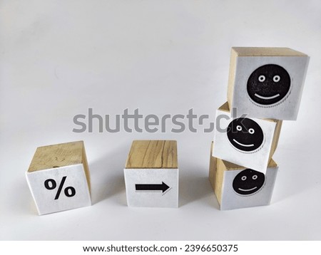 Wooden cubes in a column and row with white signs with a smiley sign, a percentage. The concept of positivism. Efforts and achievements lead to pleasure, joy, positivism and positive thinking