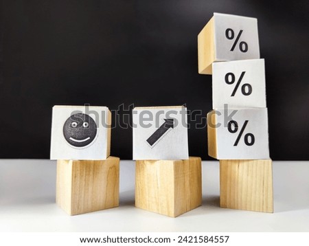 Wooden cubes in a column and row with white signs with a smiley sign, an arrow, a percentage. The concept of positivism. Positive thinking leads to the achievement of results and profits