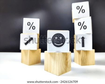 Wooden cubes in a column and row with white signs with a smiley sign, an arrow, a percentage. The concept of positivism. Positive thinking leads to the achievement of results and profits