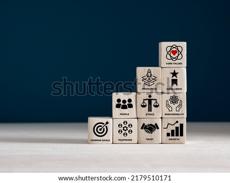 Wooden cubes with core corporate values for goal achievement and business success. Company culture, guiding principles and business strategy concept.