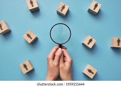 Wooden cubes with drawings of people and a magnifying glass next to them. Customer Search symbol for business - Shutterstock ID 1959215644