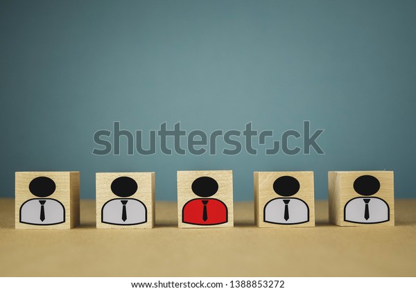 wooden cubes in the\
form of bosses and subordinates, personnel subordination on a blue\
background
