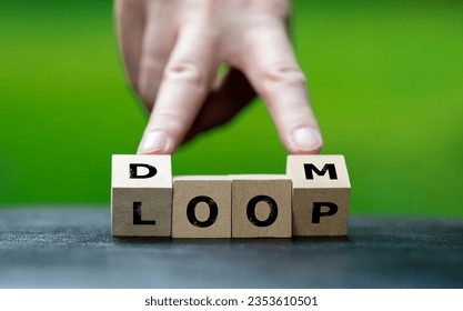 Wooden cubes form the expression 'doom loop'. Symbol for a climate doom loop.