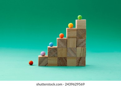 Wooden cubes forming a staircase with a different colored sphere on each step