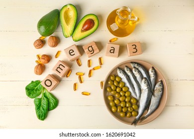 Wooden Cubes, Healthy Products With High Omega 3 And Fish Oil Pills On White Table