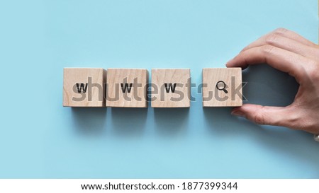 wooden cubes with the inscription: www and magnifying glass drawing. symbol for searching for something from the internet