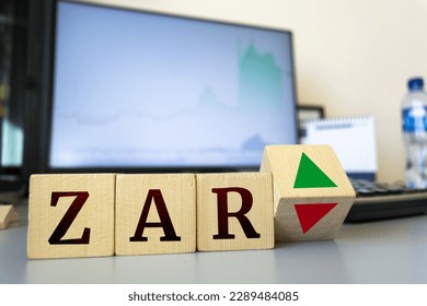 Wooden cubes with the inscription zar and a cube symbolizing the rise and fall of financial markets