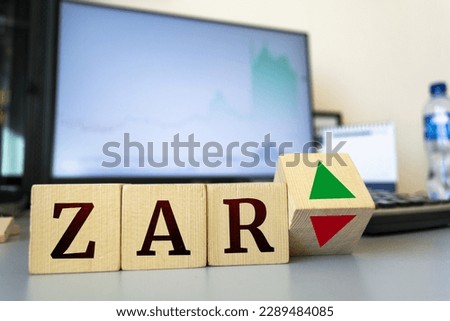 Wooden cubes with the inscription zar and a cube symbolizing the rise and fall of financial markets