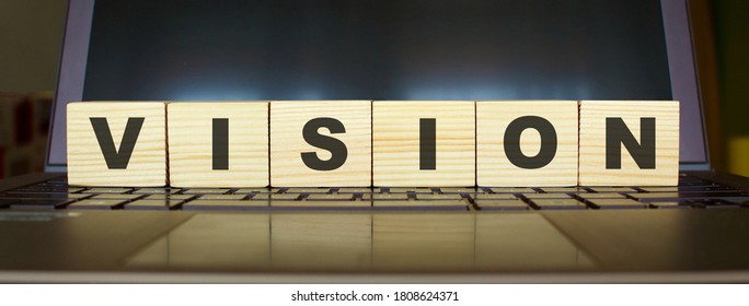 Wooden cubes with letters on a laptop keyboard. - Shutterstock ID 1808624371