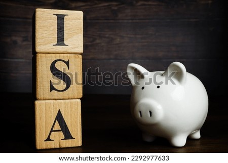 Wooden cubes with letters and piggy bank ISA Individual Savings Account.