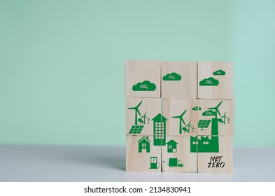 Wooden Cubes With Net Zero And Carbon Neutral Green Factory Icon Symbol Background And Copy Space.