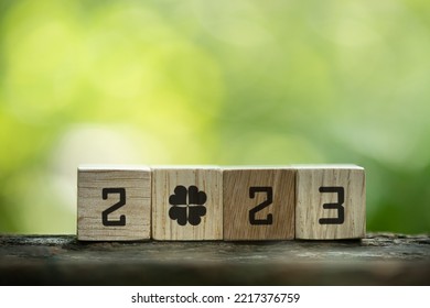 Wooden cubes with numbers 2023 on bokeh nature background.Lucky clover concept. - Shutterstock ID 2217376759