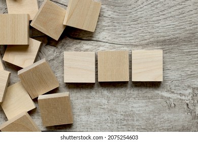 Wooden Cubes On A Wooden Background. Three Wood Blocks