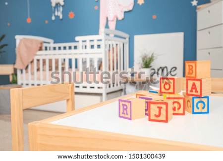 Wooden cubes on table in children's room