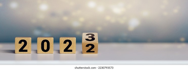 Wooden cubes on white table symbolizing the turn of the year (2022  2023) - Shutterstock ID 2230793573