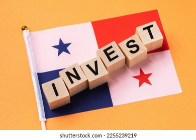 Wooden cubes with text and a flag on a colored background, the concept of investment in Panama - Shutterstock ID 2255239219