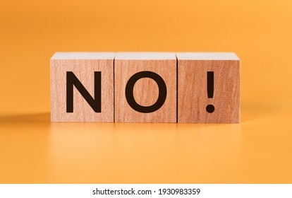 Wooden cubes with text no on a yellow background. Negative answer concept.
