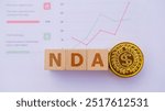 Wooden cubes with the word NDA. It is an abbreviation of Non-Disclosure Agreement. Business profitability success growth profitability analytics. Business and financial market concept.