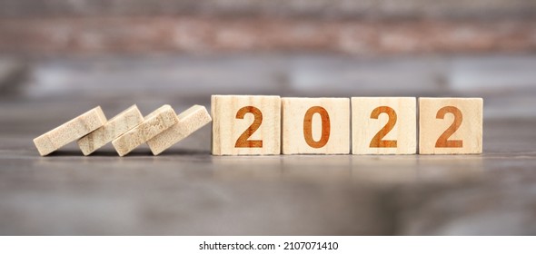 wooden cubes with writing 2022 and wooden background - Shutterstock ID 2107071410