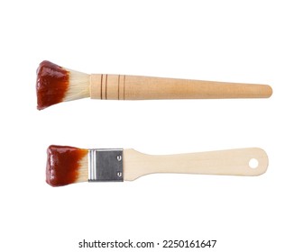 Wooden culinary brush dipped in barbecue sauce isolated on a white background. Basting brush with barbecue sauce isolated.  bbq sauce and brush. - Shutterstock ID 2250161647