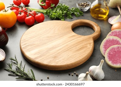 Wooden cutting board and products on dark table - Powered by Shutterstock