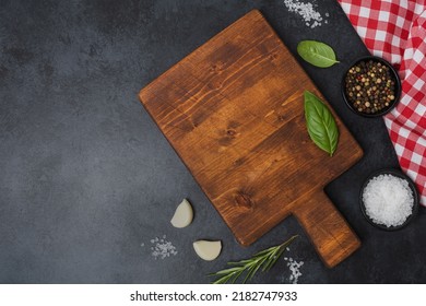 Wooden cutting board and spices, herb for food on black stone table. Menu, recipe mock up, banner background with copy space for text. Top view - Powered by Shutterstock