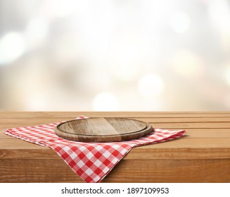 Wooden Cutting Board And Tablecloth On Wooden Table