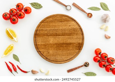 Wooden cutting board and vegetables with spices, top view. Cooking layout. - Powered by Shutterstock