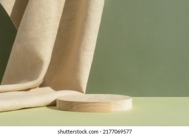 Wooden cylindrical podium, pedestal on a green background with beige curtain. Scene for the presentation of a cosmetic product. Empty showcase - Shutterstock ID 2177069577