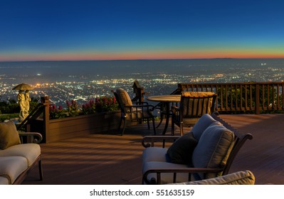 Wooden Deck / Balcony At Night With Seating Arrangement.