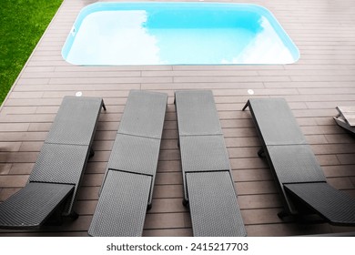 Wooden deck beach sea ocean resort sun lounger umbrella hotel pool sky sunrise. top view - Powered by Shutterstock