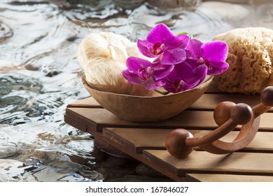 wooden deck with beauty accessories next to water