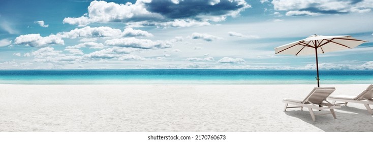 Wooden deck chairs on sandy beach near sea. Holiday background. - Powered by Shutterstock