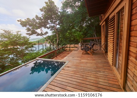 Wooden deck with pool on natural background